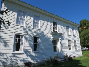 Front of House with new white paint, shutters removed